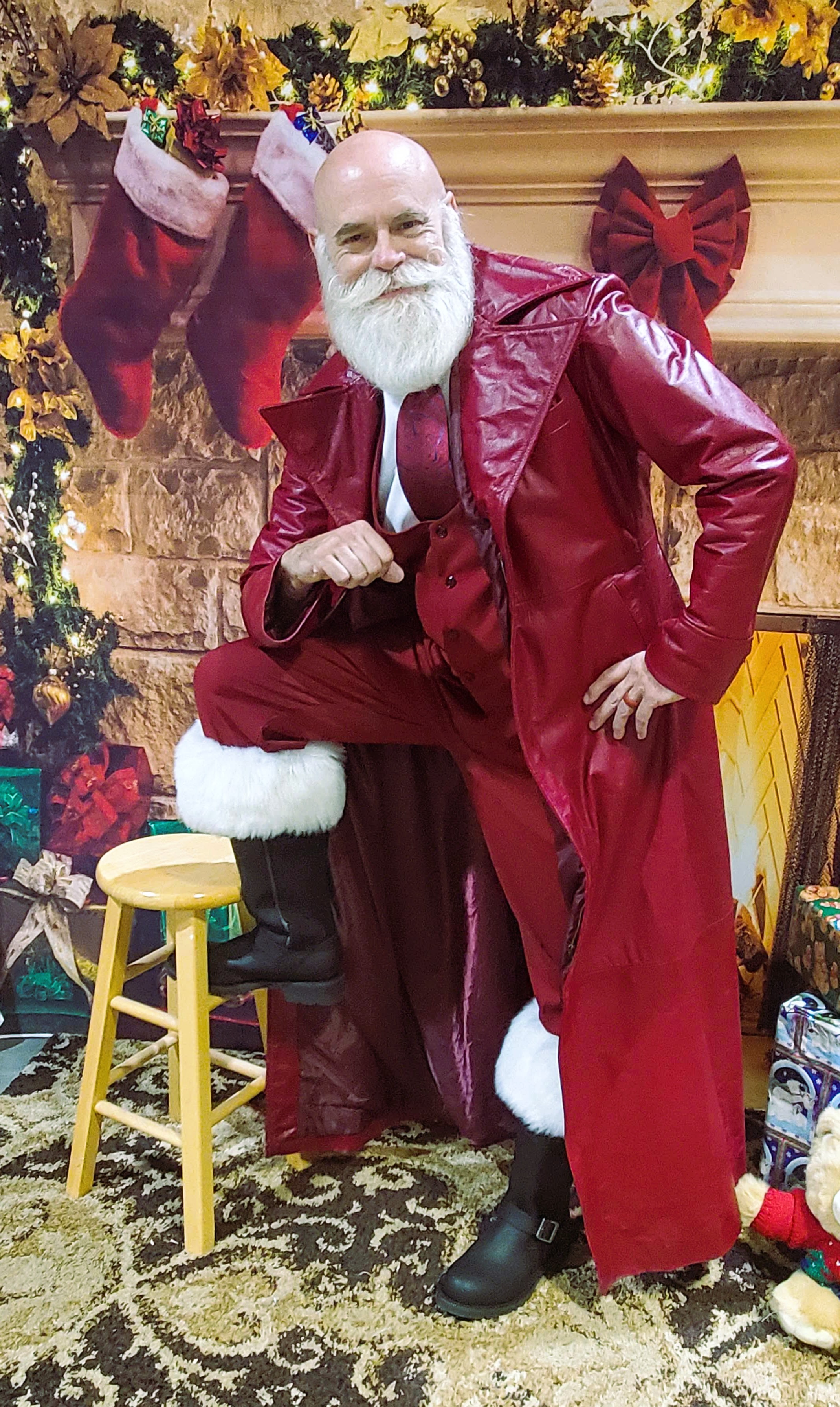 Santa posing in a tailored red leather coat and black boots